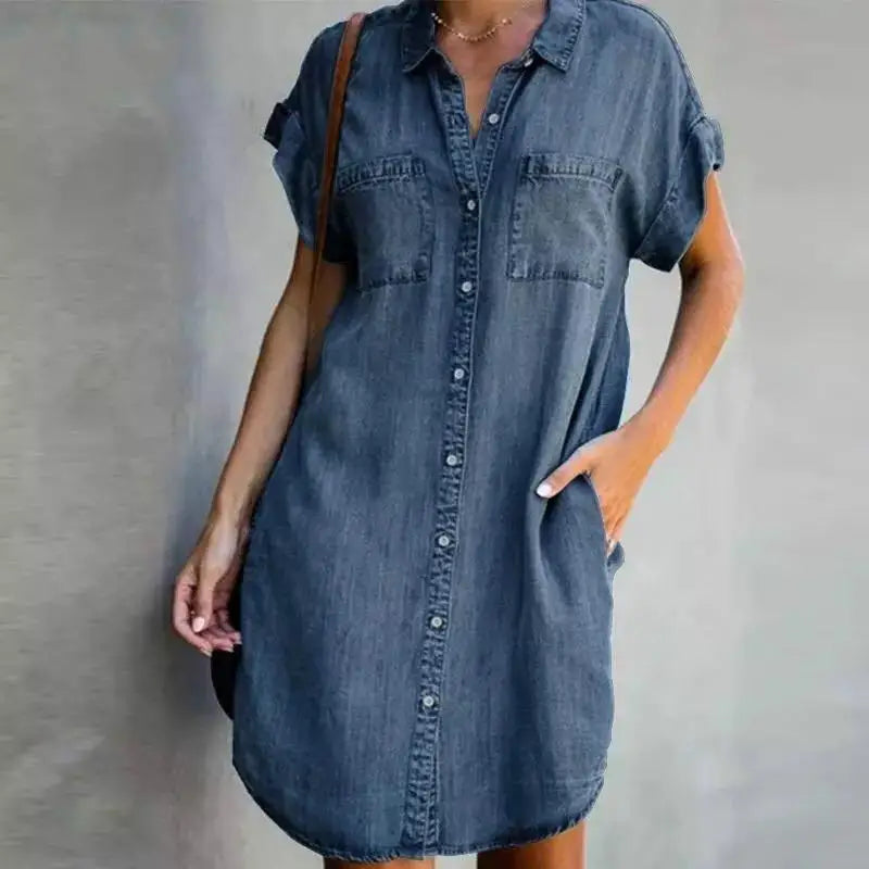Denim shirt dress worn by a person on a plain background