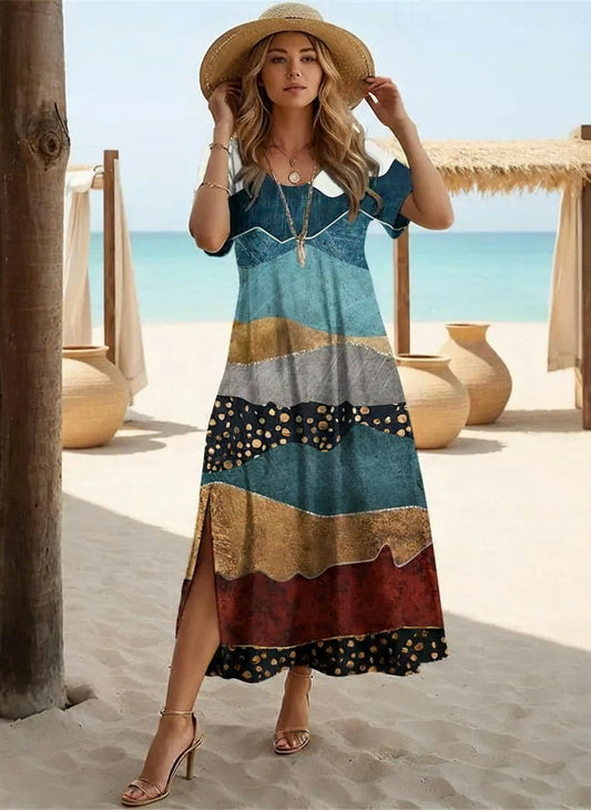 Woman in a colorful dress standing on a beach with ocean view