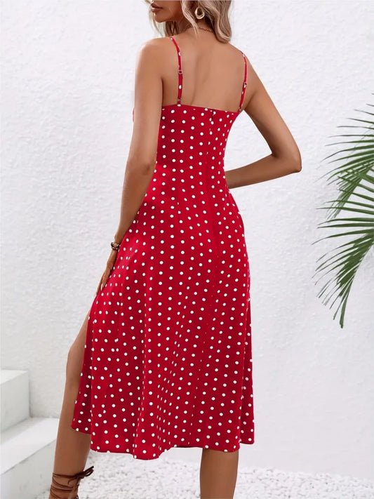 Woman wearing a red polka dot dress with a white background