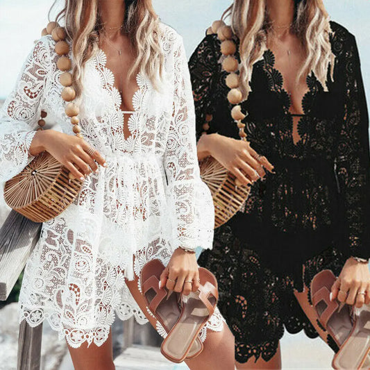 Two women wearing lace dresses with wooden beaded necklaces and holding woven handbags.