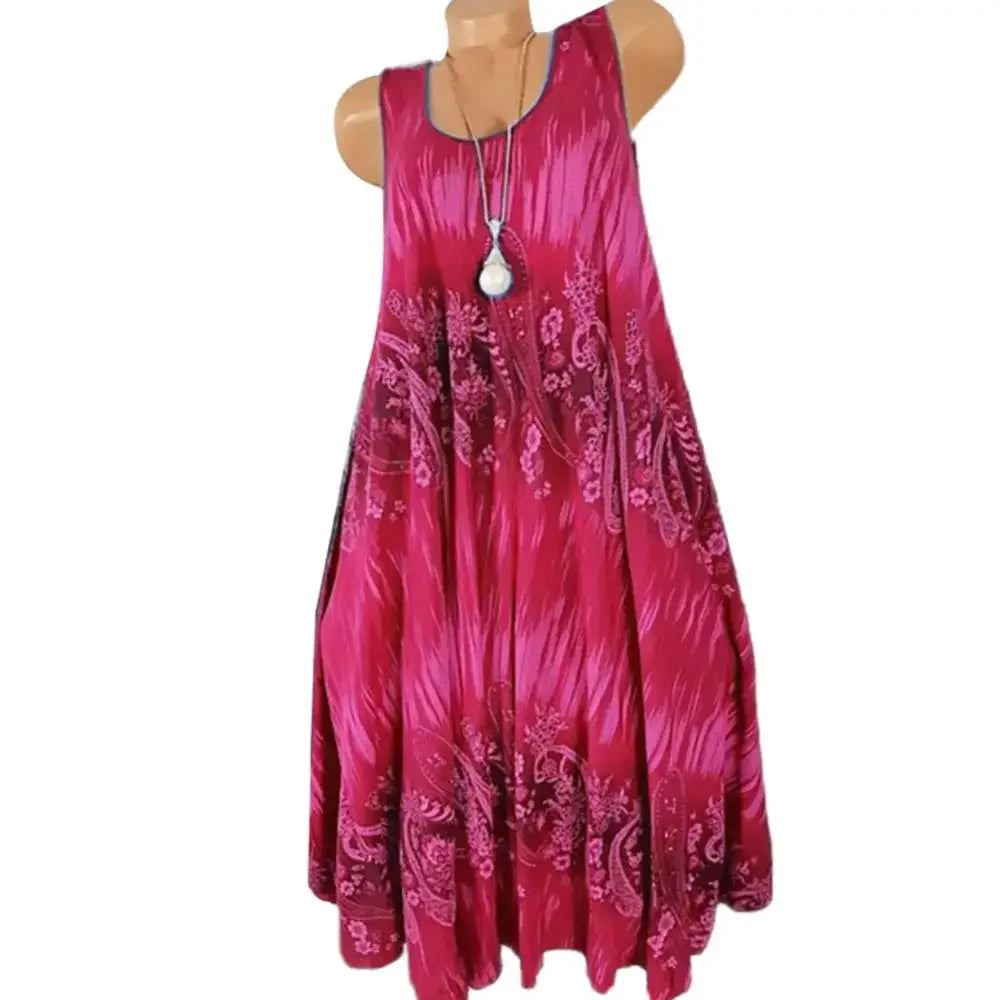 Pink sleeveless dress with paisley pattern on a mannequin against a white background