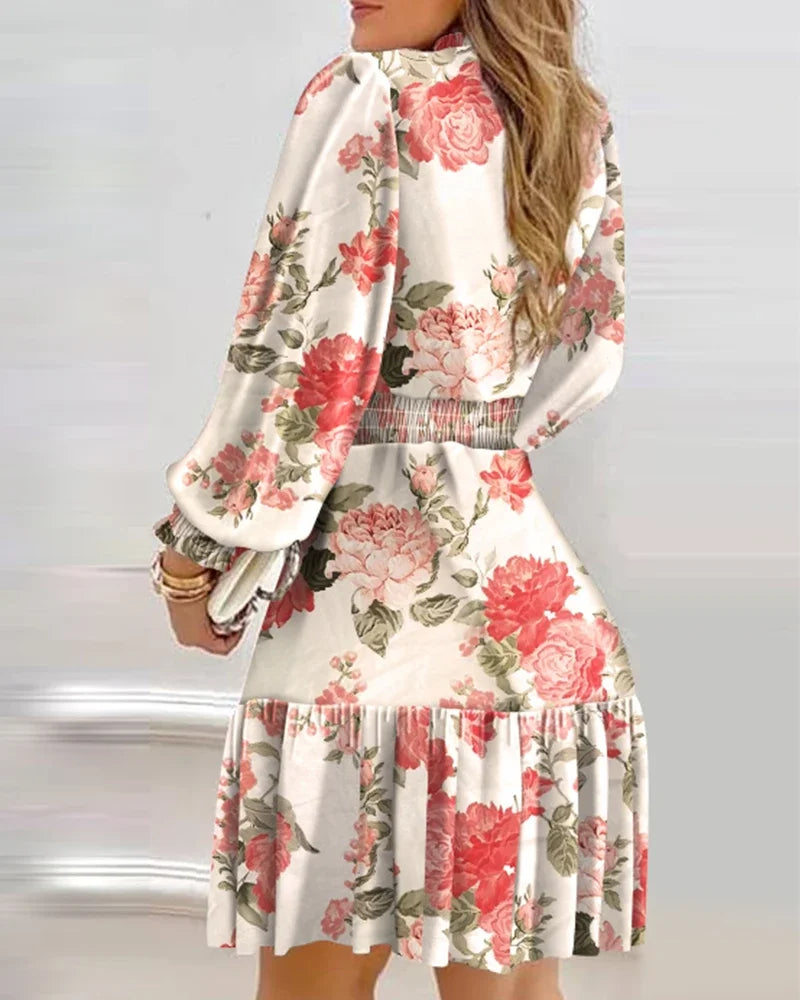 Floral dress with long sleeves on a plain background