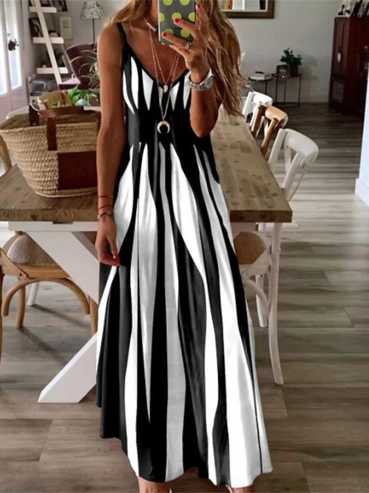Woman wearing a black and white striped dress in a home setting.
