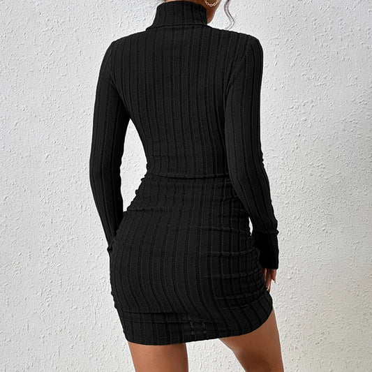 Black ribbed dress worn by a person on a white background