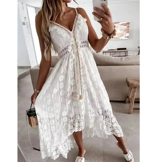 Woman in a white lace dress taking a mirror selfie in a modern living room.
