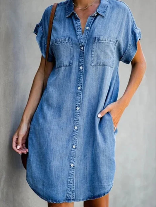 Denim shirt dress worn by a person on a plain background
