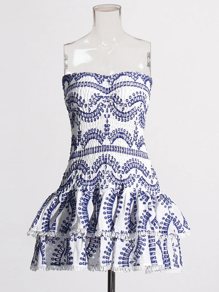 Blue and white patterned dress on a mannequin against a white background